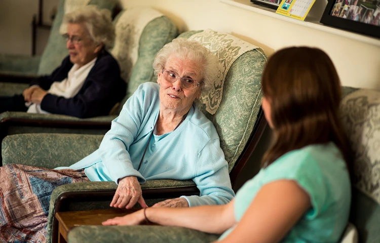 Staff and resident enjoy catching up on the latest gossip