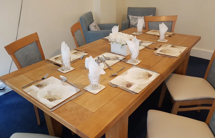 Residents in dining room set for lunch
