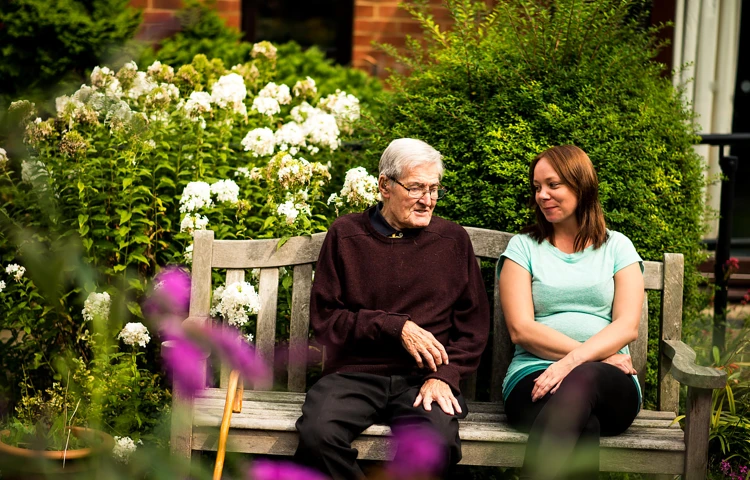 Staff and resident find time to talk in the garden at Sarnia House